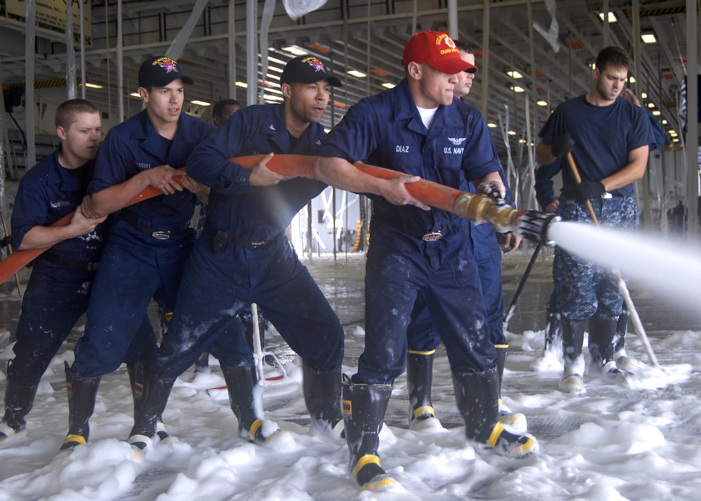 firefighters using AFFF in hangar bay