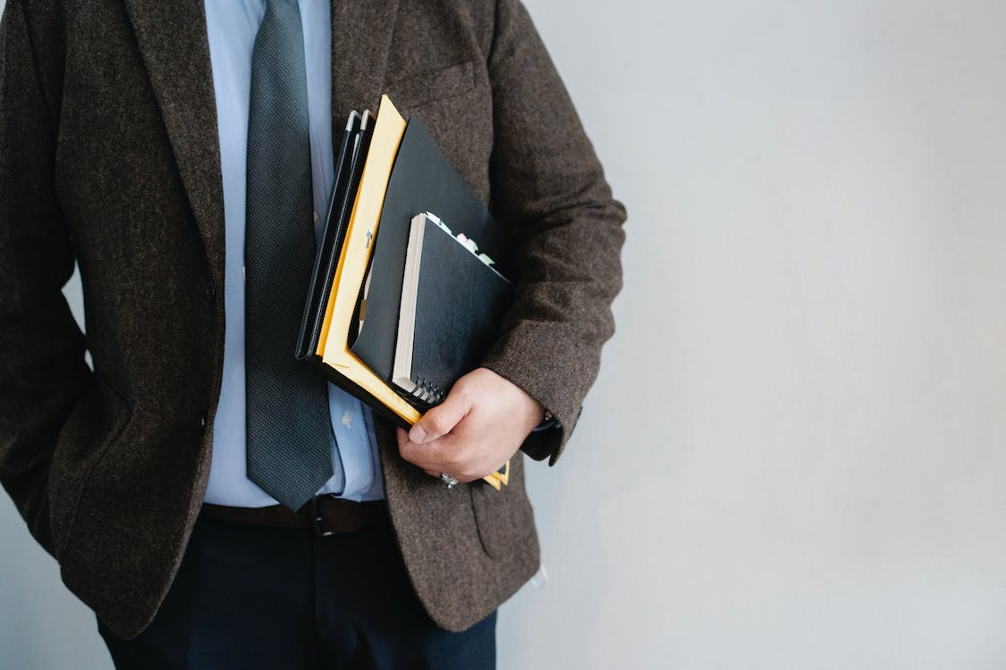 lawyer holding documents and notebook