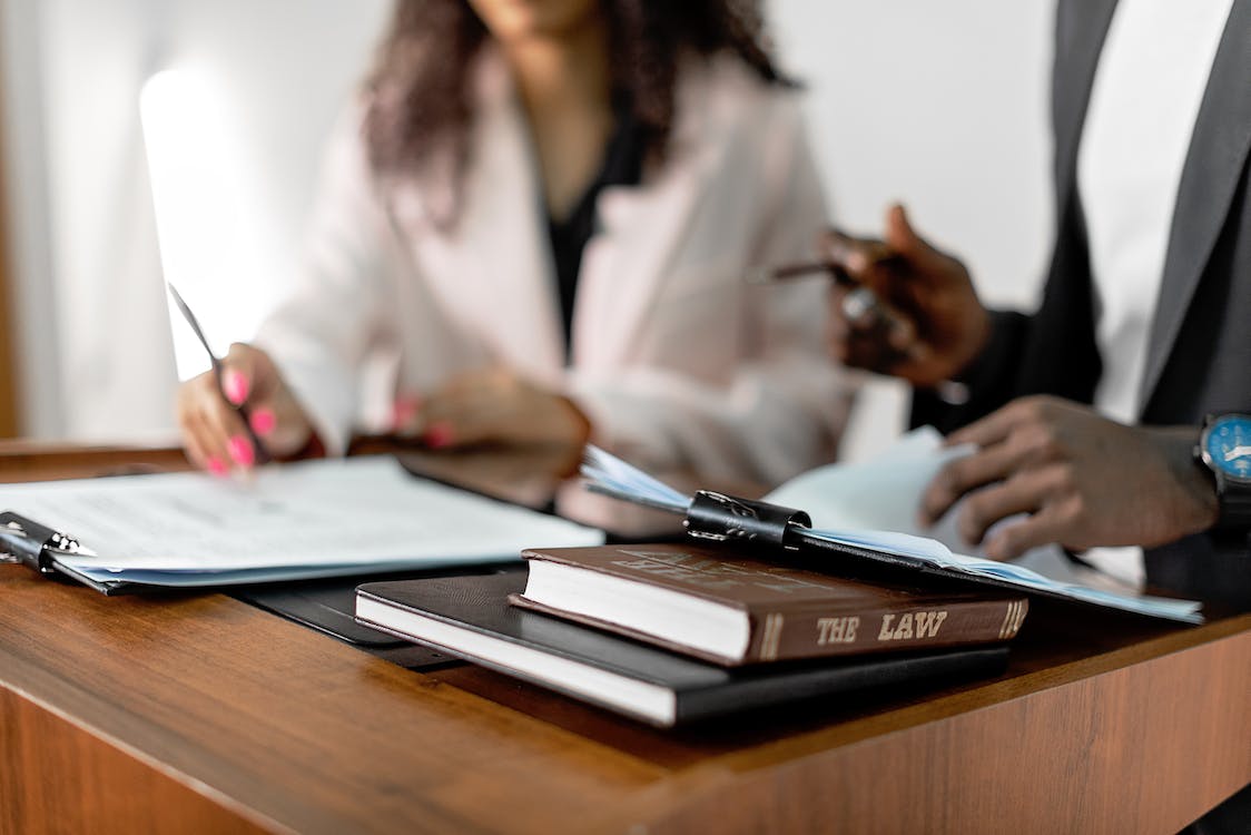 lawyers with contracts discussing a case