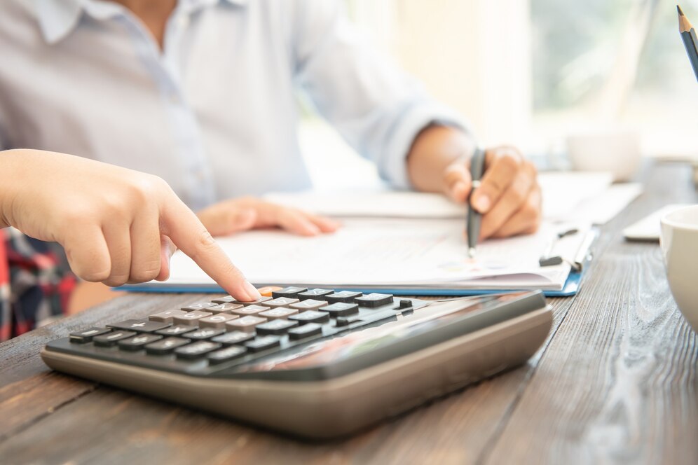 woman computing expenses with a calculator