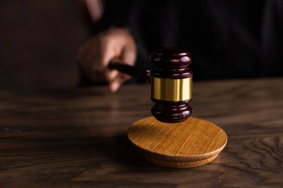 hand of judge using gavel in court